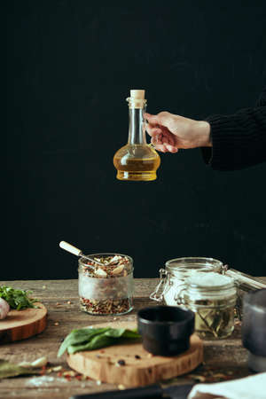 Close-up of hands preparing food in the kitchen. Cozy black background of home kitchen. The concept of healthy eating.の写真素材