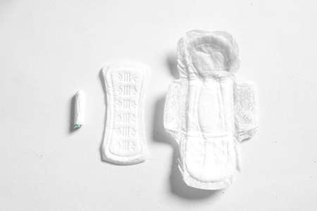 Soft white womens pads and tampon isolated on white background. Close up photography for womens or...