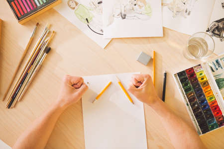 Sad guy Illustrator artist broke a pencil in the throes of creativity. State of apathy, frustration and creative crisisの写真素材