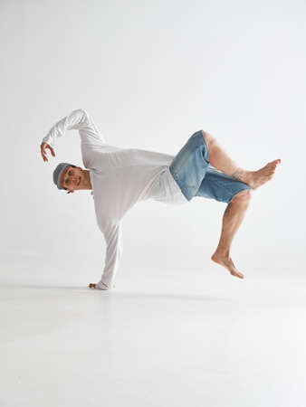 Cool guy breakdancer dancing lower break dance isolated on white background. Break dance lessons