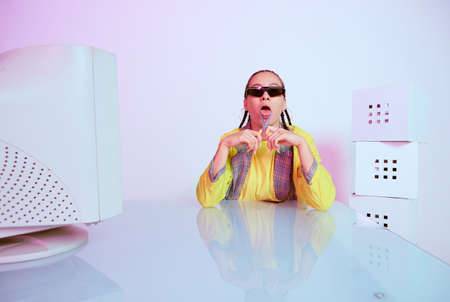 Stylish female office worker in sunglasses with obsolete computer and scissors shows tongue. Colored...