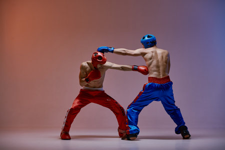 Jab of professional athletic fighter boxer, fighting guys in boxing gloves during sparring, martial arts conceptの写真素材