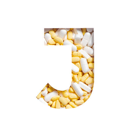 Tablets of medicines, supplements or vitamins. Letter J of alphabet isolated on white. Typeface from pills for drugstoreの写真素材