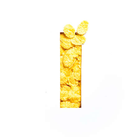 Letter I of alphabet made of bio cereals corn flakes and paper cut isolated on white. Typeface for...
