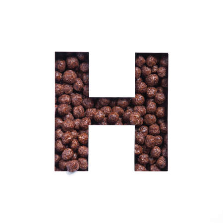 Letter H of alphabet made of bio chocolate cereal balls and paper cut isolated on white. Typeface for healthy food storeの写真素材