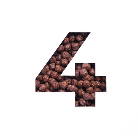 Number four of nutritional chocolate cereal balls, white paper cut in shape of fourth numeral....