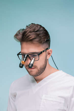 Dental Magnifiers. Male dentist with binocular medical magnifier dentistry surgical optical lens on...