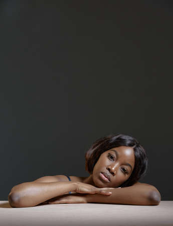 Beautiful african american young female with smooth glowing skin. Dark skin care, natural woman beauty. Copy spaceの写真素材