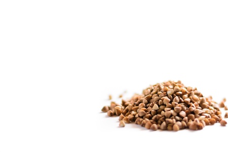 Pile of buckwheat grains on white bacground の写真素材