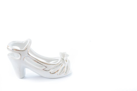 Porcelain light shoe with gold bordering on the white background の写真素材
