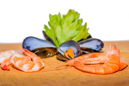 Detail of Sea food - shrimp, mussel, ink-well  with green decoration on white background.の写真素材