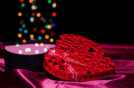 Open gift box shaped heart with Bokeh