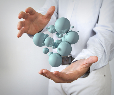 connection concept: glossy 3d balls between handsの写真素材