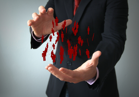 communications technology businessman: people silhouettes connected on the hand of a businessmanの写真素材