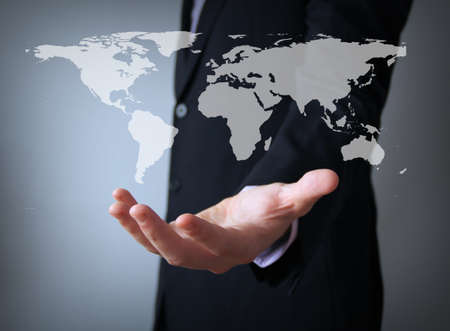 world map over businessman handの写真素材