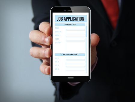 job search concept: businessman hand holding a touch phone with online job application on the screenの写真素材