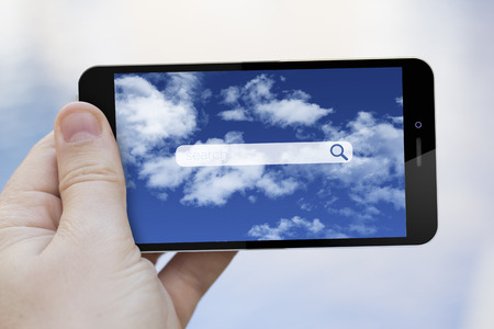 search concept: hand holding a 3d generated smartphone with search interface on the screenの写真素材