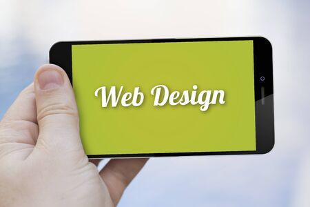 communications and marketing concept: hand holding a web design 3d generated smartphone. Screen graphics are made up.の写真素材