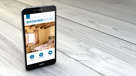 digital generated smartphone with booking website over white wooden background. All screen graphics are made up.の写真素材