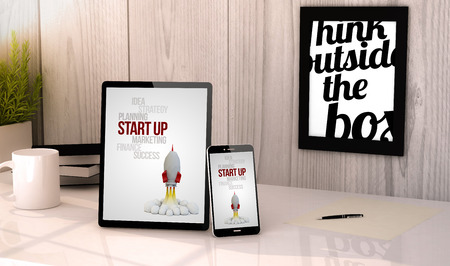 Digital generated tablet and phone on a desktop workplace with start up on screen.の写真素材