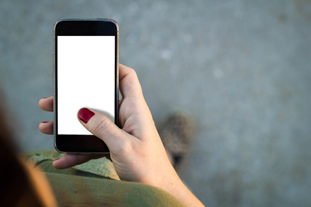 Top view of woman walking in the street using her mobile phone.