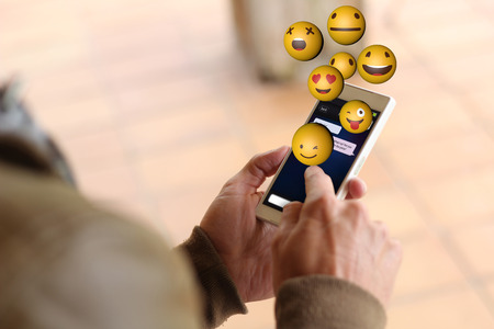 man touching the screen of his smartphone showing instant messaging app. All screen graphics are made up.の写真素材