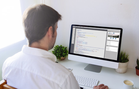 man programming a website. All screen graphics are made up.