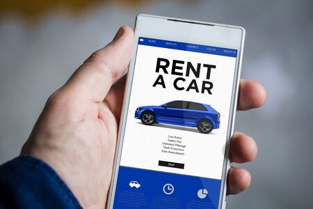 man hand holding rent a car smartphone. All screen graphics are made up.の写真素材