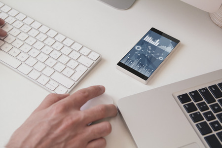 office desktop with finances screen smartphoneの写真素材