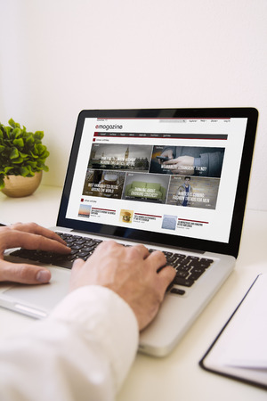 man using laptop showing emagazineの写真素材