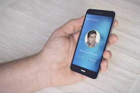 hand with digital generated smartphone with social network connection interface. Screen graphics are made up.の写真素材