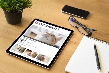 ablet on desktop showing funny cats videos on video streaming portalの写真素材