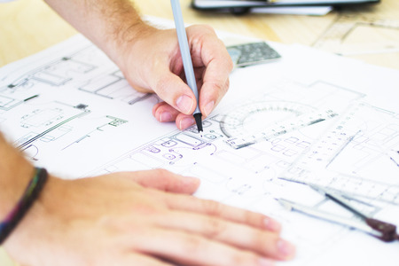 architect working drawing blueprintes