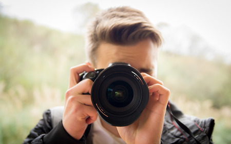 Young man making photosの写真素材