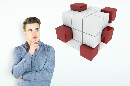 Blue eyed boy thinking with cubes problemの写真素材