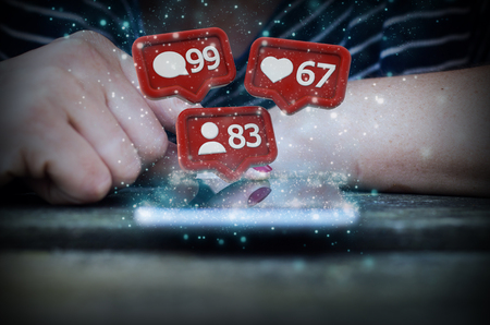 Woman hand touch smartphone screen with social media iconsの写真素材