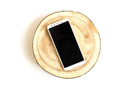 Smartphone mock up over wooden cut top viewの写真素材