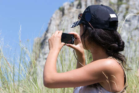 Young girl taking a snapshotの写真素材