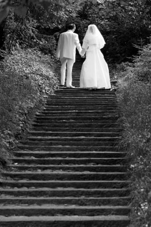 Wedding couple going up stairsの写真素材