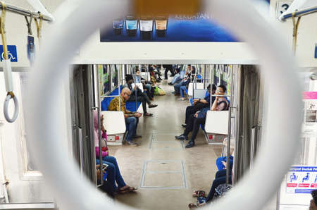 A train scene look through a hole of a hanging handrailのeditorial素材