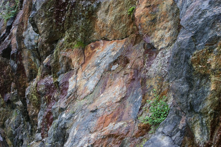 Colored granite mountain rocks as interesting background