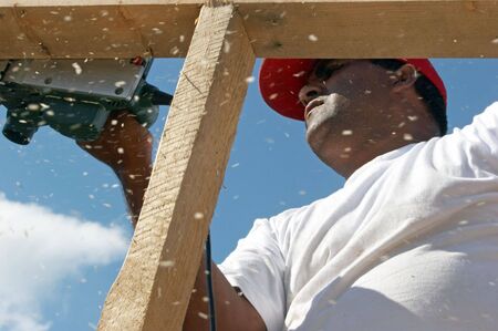 Worker polishing wood frame on top の写真素材