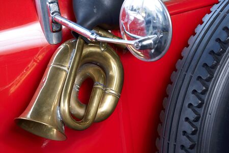 Old red car with brass horn and mirrorの写真素材
