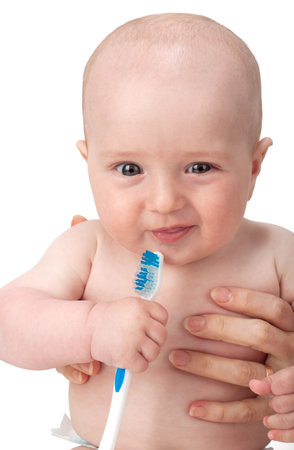 Little lovable boy playing with a new toothbrushの写真素材