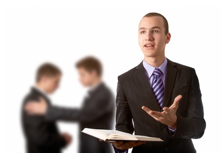Young man preach the Gospel and other two praying in backgroundの写真素材