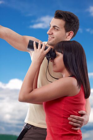 Portrait of happy young couple looking for beauties of natureの写真素材