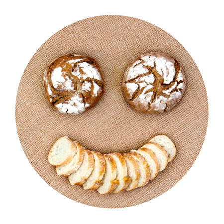 Smiling emoticon with round bread and slices on hemp canvas representing diet healthy food