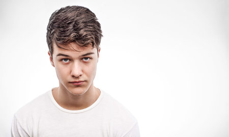 Young handsome man in red blouse looking aheadの写真素材