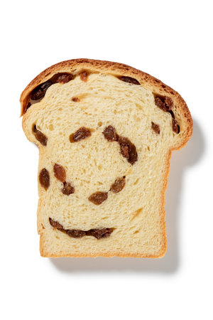 Savor the warmth of home with a single slice of tender raisin bread, adorned with plump raisins baked to perfection, the essence of homemade goodness, promising a comforting taste of tradition.の写真素材