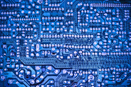 closeup of the blue electronic circuit boardの写真素材